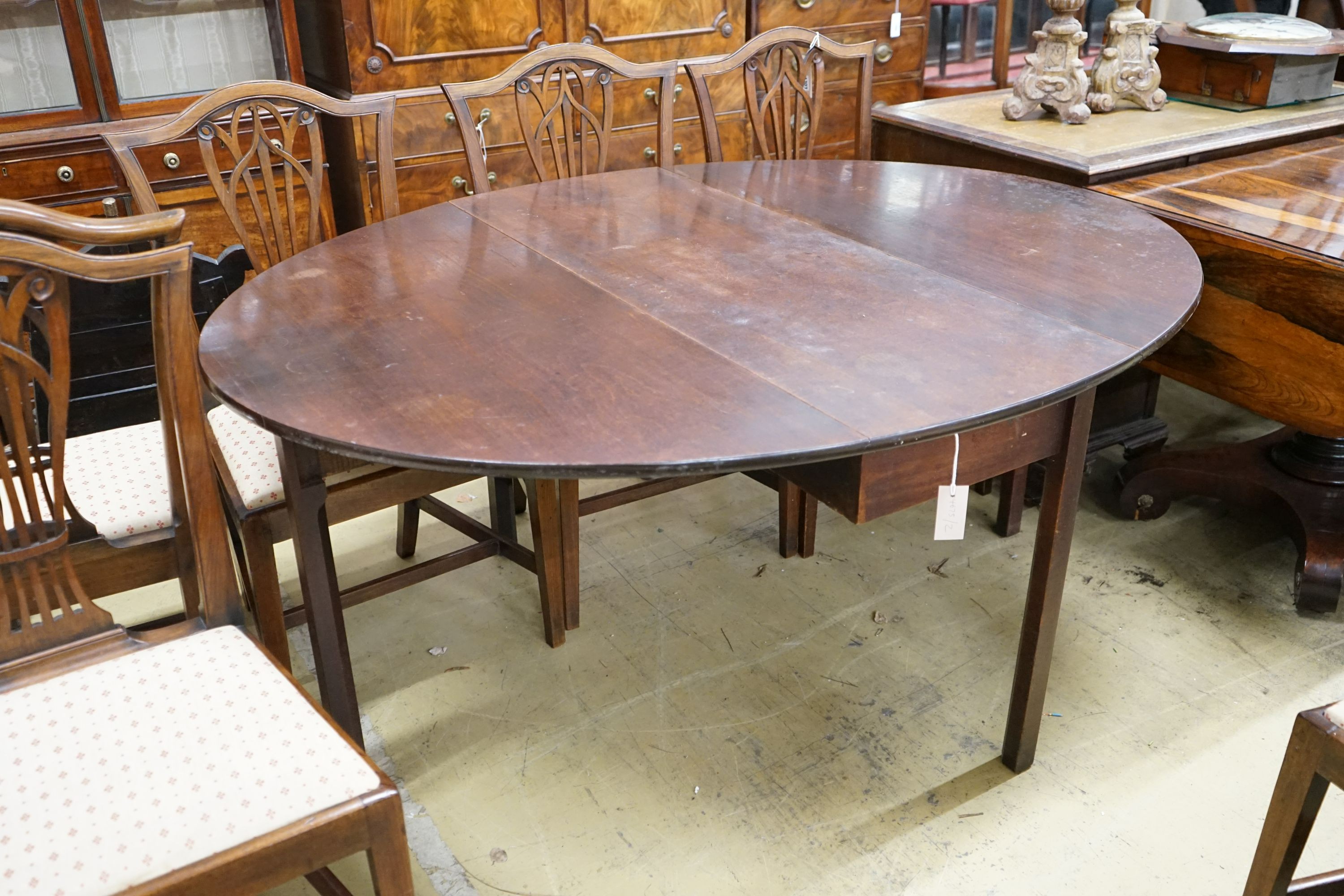 A George III oval mahogany drop leaf dining table, length 160cm extended, width 123cm, height 72cm